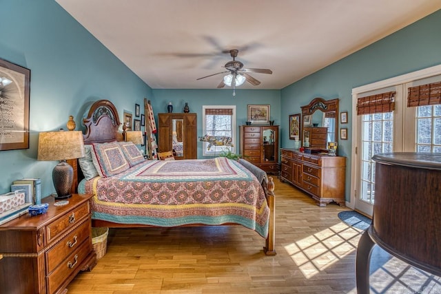 bedroom with light wood finished floors, access to outside, and ceiling fan