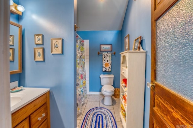 bathroom with a shower with curtain, vanity, toilet, and tile patterned floors