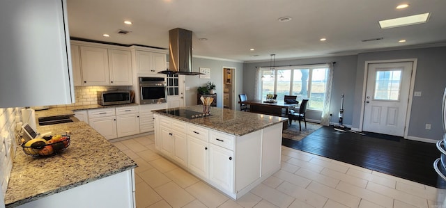 kitchen with visible vents, decorative backsplash, island exhaust hood, stainless steel appliances, and crown molding