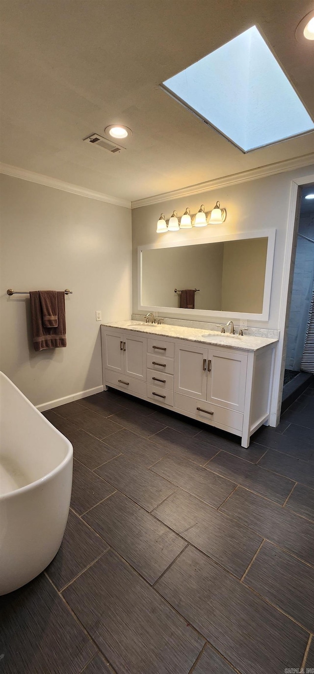 full bath featuring double vanity, a sink, visible vents, and crown molding