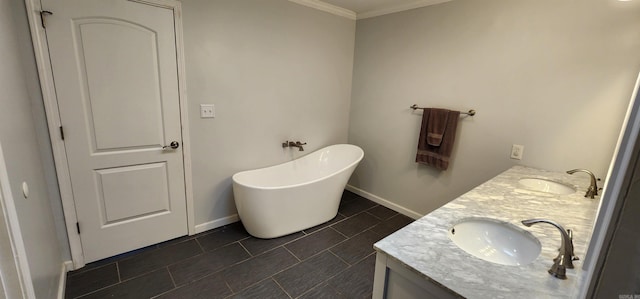 bathroom featuring a soaking tub, a sink, baseboards, and double vanity