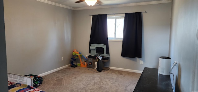 rec room with ornamental molding, carpet, baseboards, and a ceiling fan