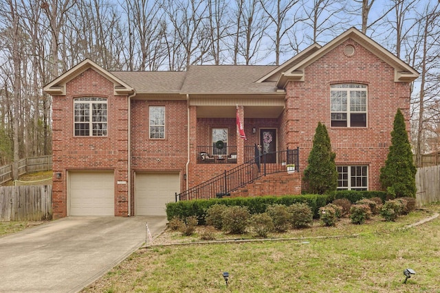 view of front of property with a garage, concrete driveway, brick siding, and fence