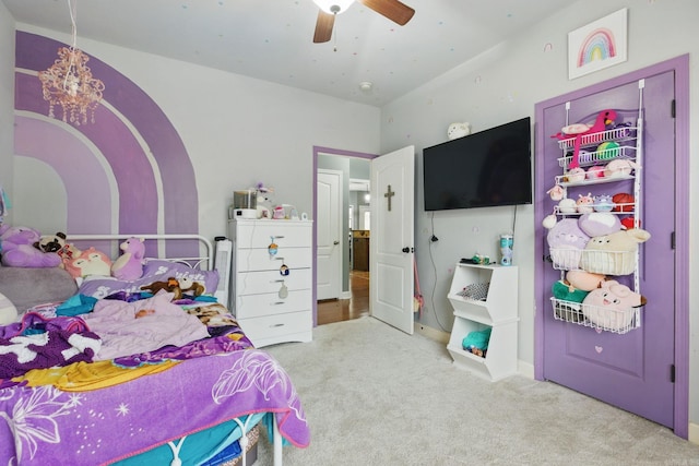 bedroom with ceiling fan with notable chandelier and carpet