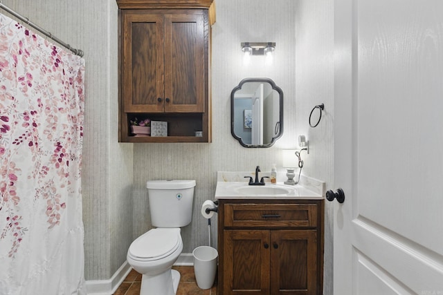 bathroom with toilet, curtained shower, vanity, and tile patterned floors