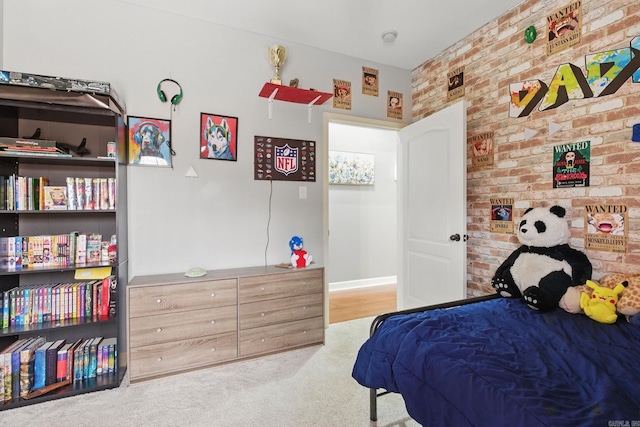 carpeted bedroom featuring brick wall