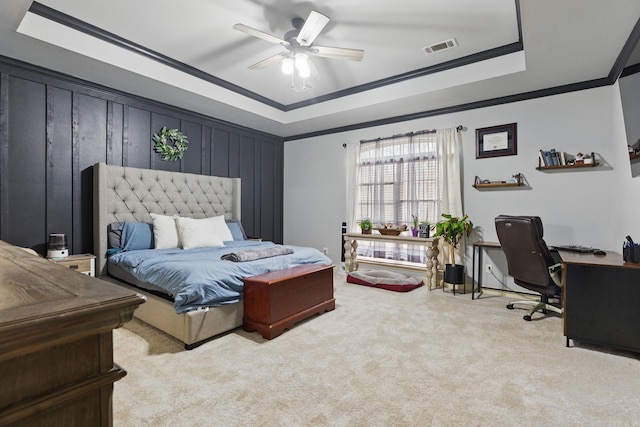 bedroom with carpet floors, a raised ceiling, visible vents, and crown molding