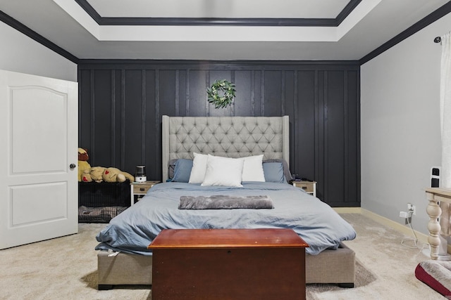 bedroom featuring carpet floors, ornamental molding, a tray ceiling, and baseboards