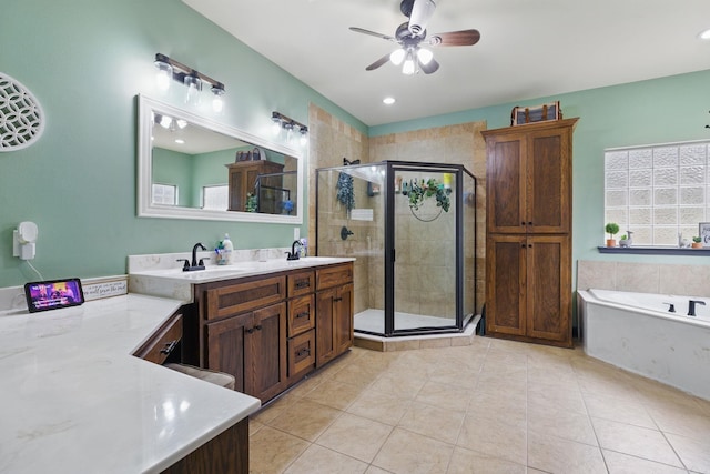 bathroom featuring double vanity, a sink, tile patterned flooring, a shower stall, and a bath