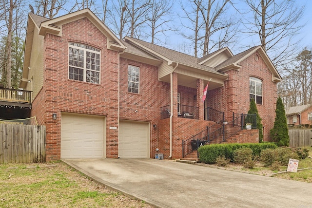 view of front of house with stairs, concrete driveway, and brick siding