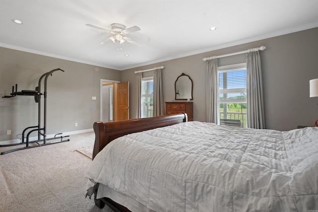 carpeted bedroom with baseboards, a ceiling fan, and crown molding