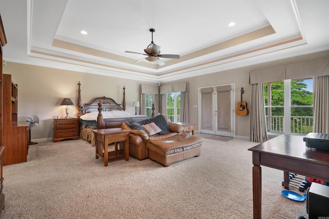 bedroom featuring a tray ceiling, crown molding, access to exterior, and light colored carpet