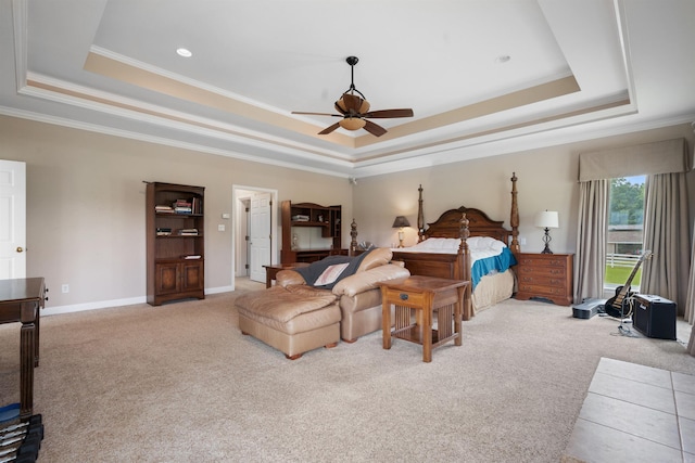 bedroom with ornamental molding, a tray ceiling, and carpet floors