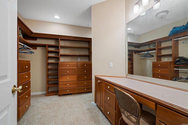 spacious closet featuring light carpet