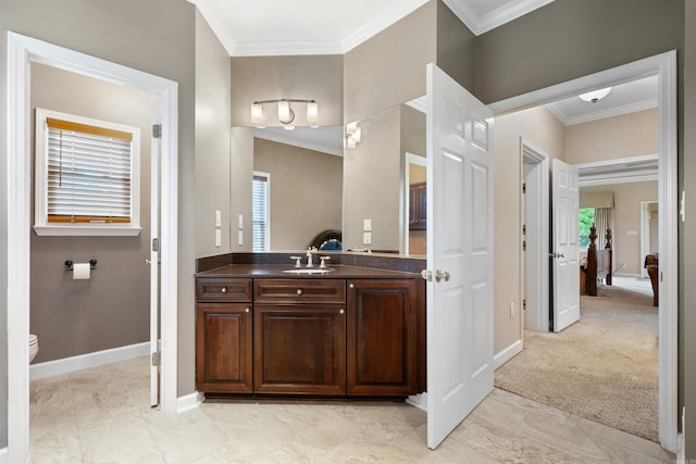 bathroom featuring baseboards, toilet, ornamental molding, and vanity