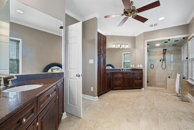 bathroom with visible vents, a stall shower, crown molding, and a sink