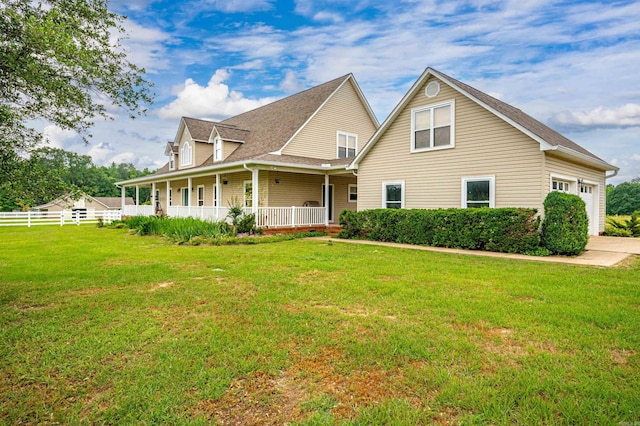 farmhouse with a porch, a front yard, and fence