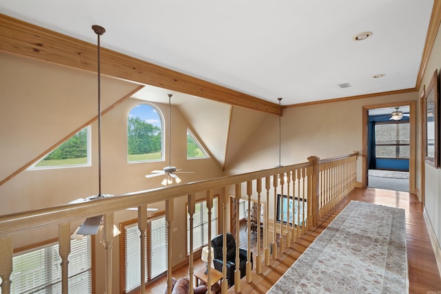 corridor with wood finished floors, visible vents, high vaulted ceiling, beam ceiling, and ornamental molding