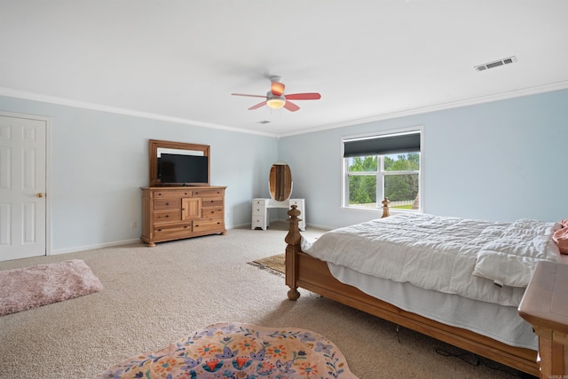 carpeted bedroom featuring visible vents, baseboards, a ceiling fan, and crown molding