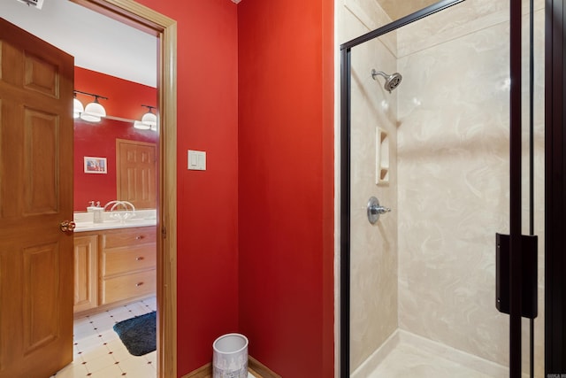 bathroom with tile patterned floors, a shower stall, and vanity