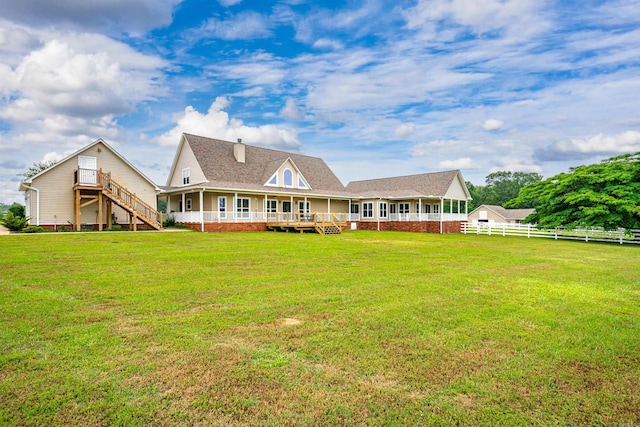 back of house with a shingled roof, fence, stairway, a chimney, and a yard