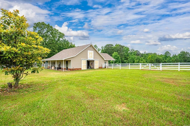 view of yard with an outdoor structure, fence, and an outbuilding