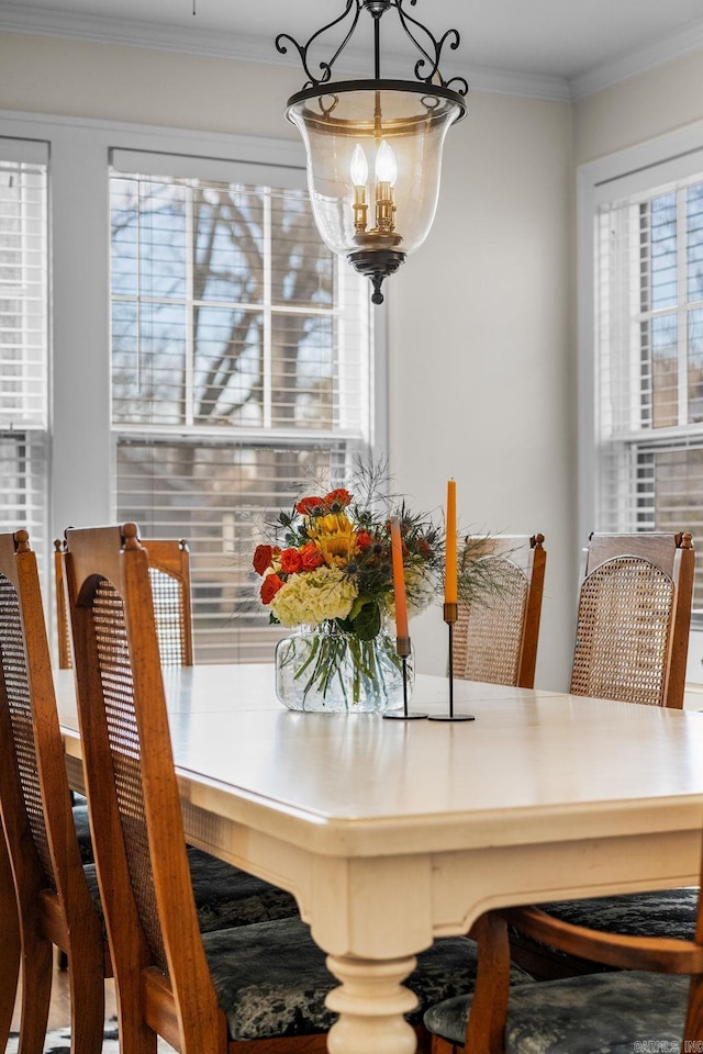 dining space featuring a chandelier and ornamental molding