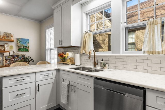 kitchen with a sink, light stone counters, crown molding, decorative backsplash, and dishwasher