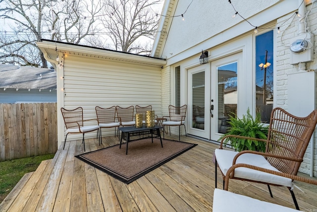 wooden deck featuring french doors and fence