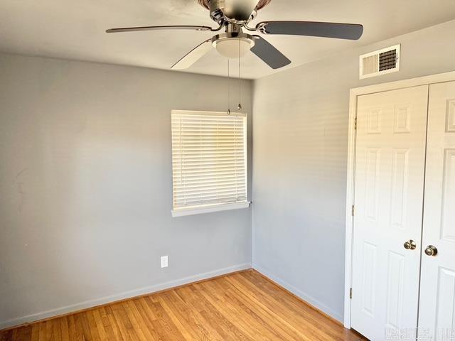 unfurnished bedroom with visible vents, baseboards, a closet, and light wood-style flooring