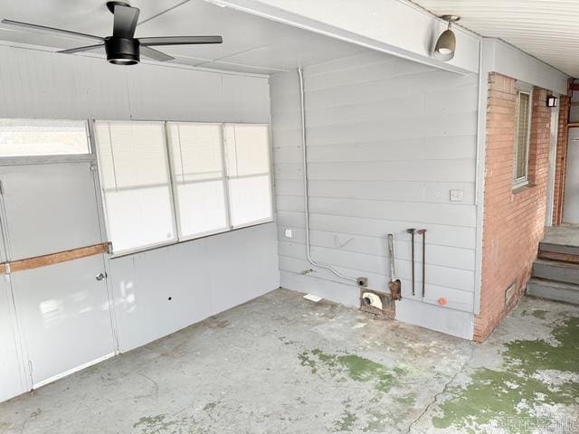 interior space with ceiling fan