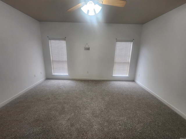 spare room with carpet flooring, ceiling fan, and baseboards