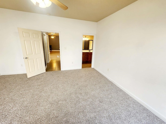 unfurnished bedroom featuring baseboards, carpet floors, and ensuite bathroom