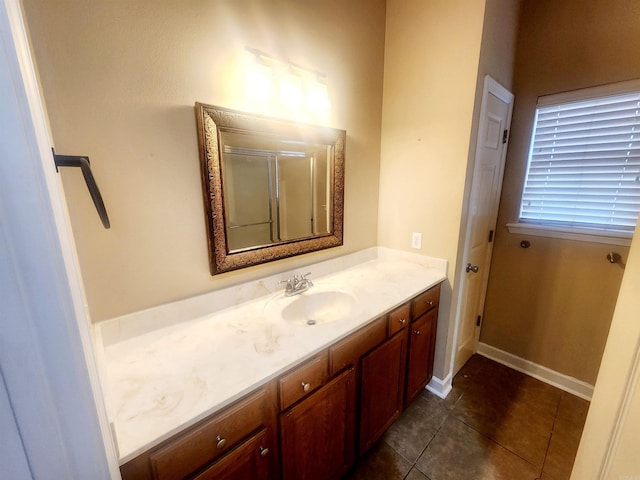 bathroom featuring baseboards, vanity, and tile patterned flooring