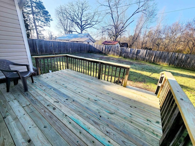 wooden deck with a yard and a fenced backyard