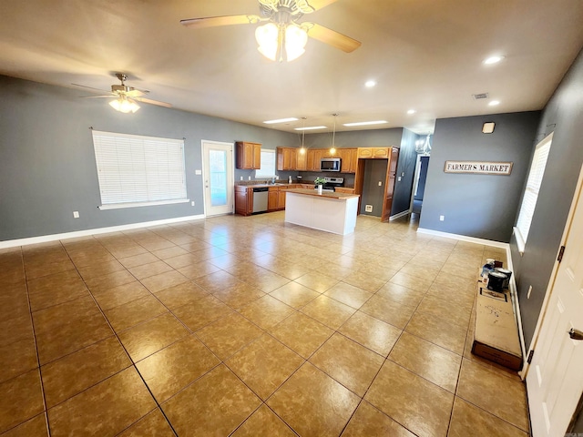 kitchen featuring open floor plan, visible vents, appliances with stainless steel finishes, and baseboards