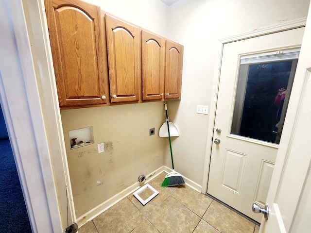 washroom with washer hookup, cabinet space, light tile patterned floors, baseboards, and hookup for an electric dryer