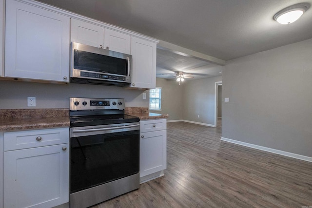 kitchen with baseboards, ceiling fan, stainless steel appliances, white cabinets, and light wood-style floors