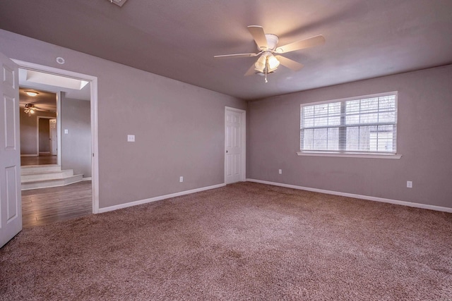 empty room featuring baseboards, ceiling fan, and carpet floors