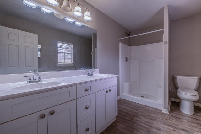 full bath featuring wood finished floors, toilet, walk in shower, and a sink