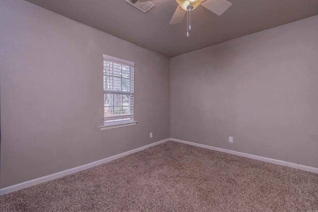 spare room with visible vents, baseboards, carpet, and a ceiling fan