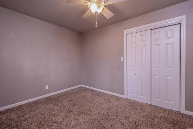 unfurnished bedroom featuring a closet, baseboards, carpet, and ceiling fan