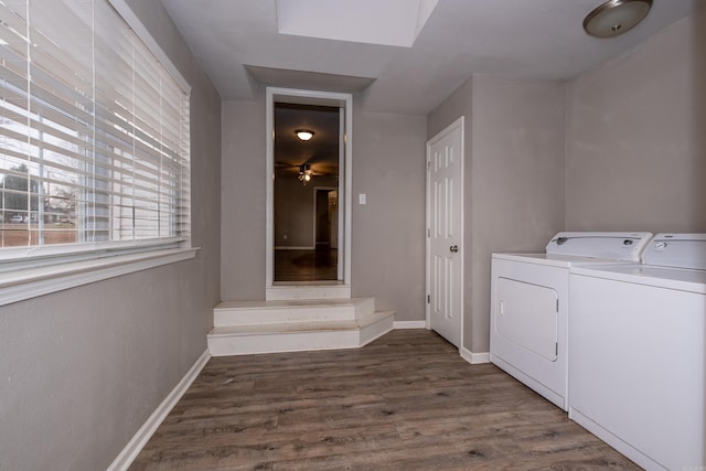 laundry area with baseboards, wood finished floors, laundry area, and washing machine and clothes dryer