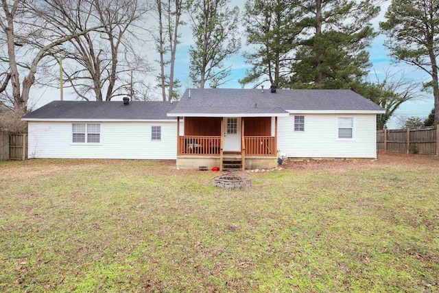 rear view of house featuring crawl space, a fire pit, a lawn, and fence private yard