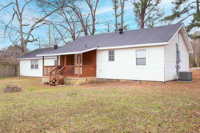 back of house with an outdoor fire pit, a yard, a shingled roof, crawl space, and central AC unit