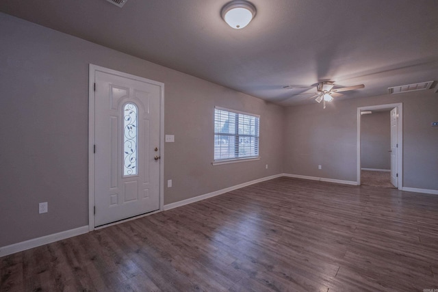 entrance foyer featuring visible vents, a ceiling fan, baseboards, and wood finished floors