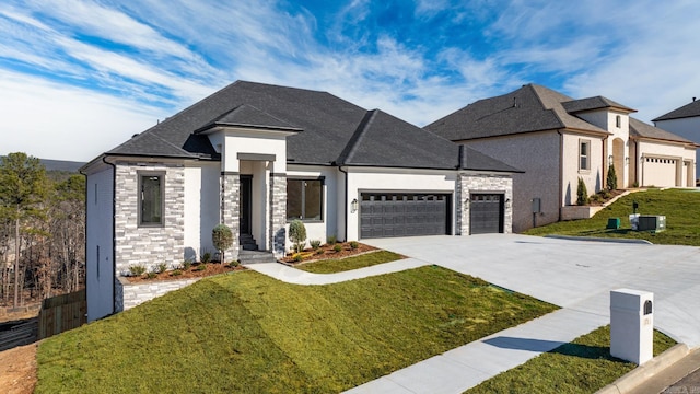 view of front facade featuring stone siding, a front lawn, concrete driveway, and an attached garage