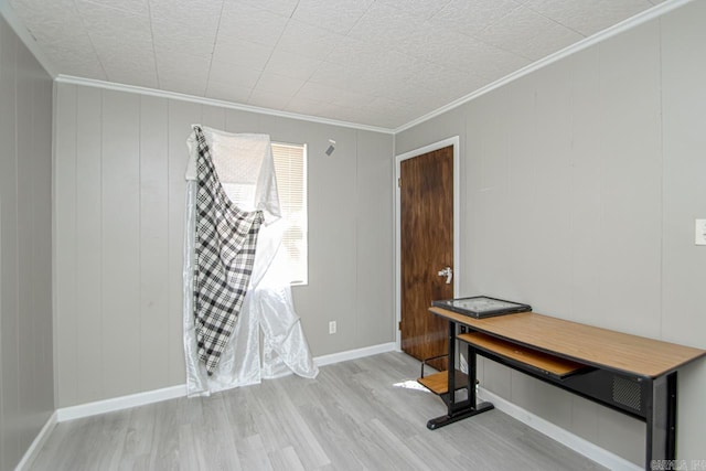 home office with baseboards, wood finished floors, and ornamental molding