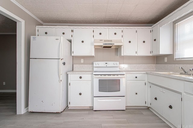 kitchen featuring ornamental molding, under cabinet range hood, white cabinetry, white appliances, and light countertops