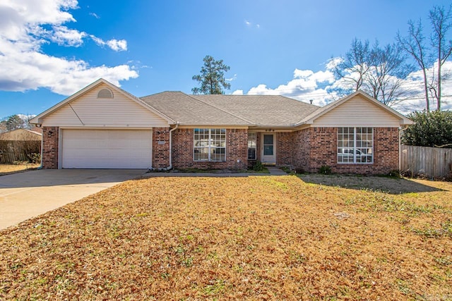 ranch-style home featuring a front lawn, driveway, fence, a garage, and brick siding